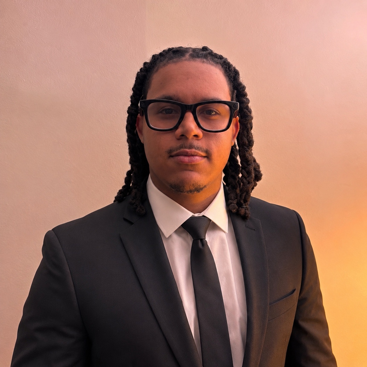 Dylon D. Feagin wearing a black suit and glasses